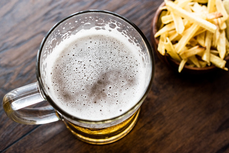 Glass of Beer with potato chips. Beverage concept.の写真素材