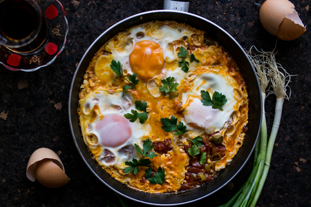 Menemen is a traditional Turkish dish which includes eggs, tomato, green peppers, and spices such as ground black pepper, ground red pepper, salt and oregano.の写真素材