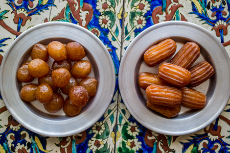 They are a fried batter soaked in syrup, similar to jalebis and churros.の写真素材