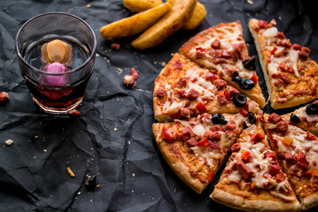 Pizza is a flatbread generally topped with tomato sauce and cheese and baked in an oven.の写真素材