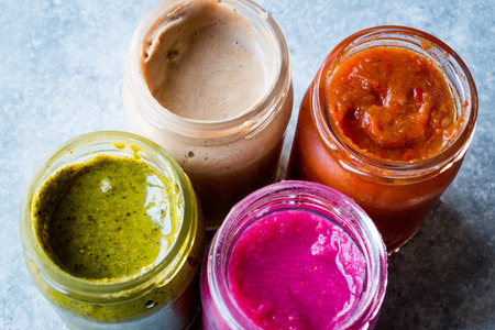 Jar of Beet Dip Sauce, Almond Butter or Tahini Pistachio Urbech and Salsa (Tomato Paste) Sauce. Organic Food.の写真素材