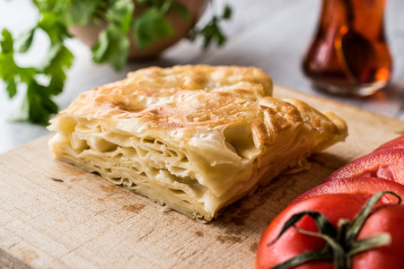 Su Boregi / Turkish Patty with tea on wooden surface.の写真素材