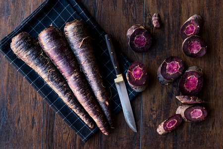 Purple Carrots on Dark Wooden Surface. Organic Food.の写真素材