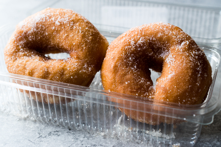 Sugared Donuts in Plastic Box. FastFood.