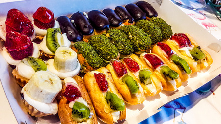 Assortment of French Dessert Eclairs in white box. Dessert Concept.