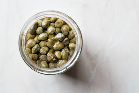 Jar of Capers in Glass Bowl. Organic Food.の写真素材