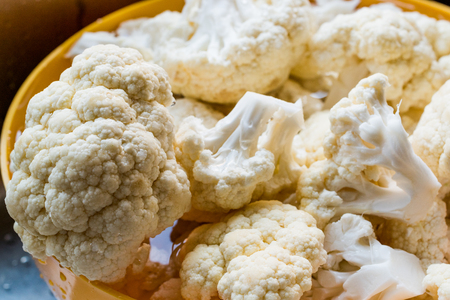 Fresh Heads Cleaned Cauliflower in yellow bowl. Organic Food.の写真素材
