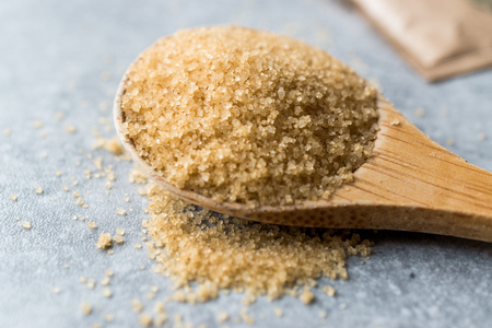 Brown Sugar in Wooden Spoon with Package. Organic Food.の写真素材