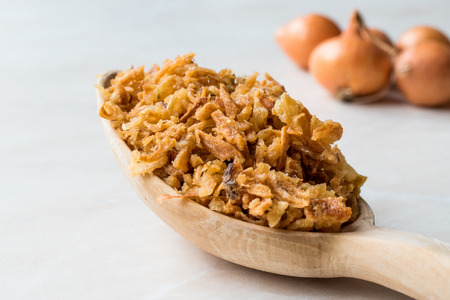 Fried Crispy Onion Flakes with Wooden Spoon. Organic Food.の写真素材