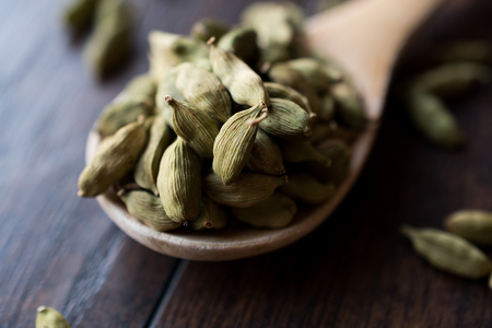 Cardamom Seeds in Wooden Spoon. Organic Product.の写真素材