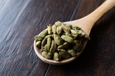 Cardamom Seeds in Wooden Spoon. Organic Product.の写真素材