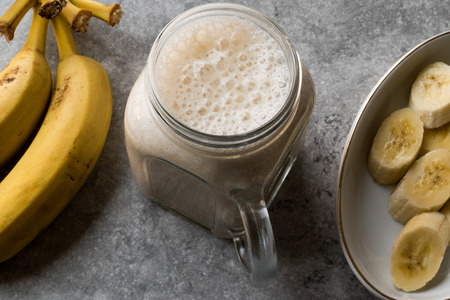 Milky Banana Smoothie in Mason Jar with Milk (Milkshake). Organic Beverage.の写真素材