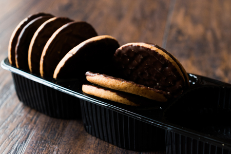 Chocolate Covered Round Jaffa Cookies in Plastic Box / Container. Dessert Concept.の写真素材