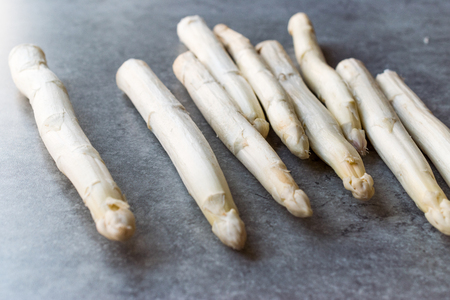 Organic Raw White Asparagus on Blue Surface. Healthy Food.の写真素材