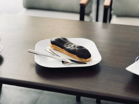 Chocolate Eclairs Served with Plate at Restaurant. Dessert Concept.の写真素材