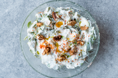 Walnut Salad with Purslane and Yogurt in Glass Bowl. Fresh Organic Food.