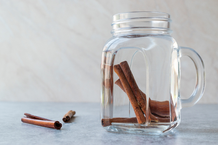 Water with Cinnamon Sticks in Mason Jar. Organic Beverage.の写真素材