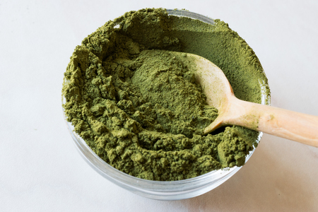 Green Matcha Tea Powder with Wooden Spoon and Glass Bowl. Organic Product.の写真素材