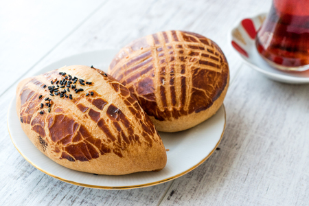 Turkish Pastry Pogaca with Tea / Cay on white wooden surface. Traditional Bakery