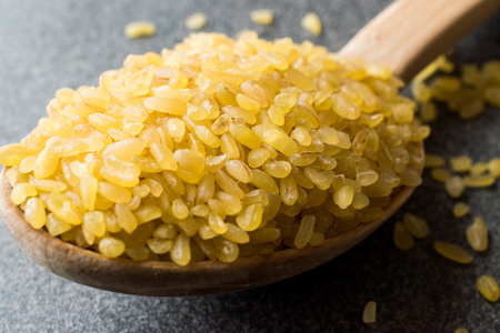 Dry Bulgur Wheat in Wooden Spoon / Bulghur. Organic Product.の写真素材