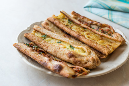 Turkish Pastry Konya Mevlana Pide with Cubed Meat and Melted Cheese. Traditional Food.