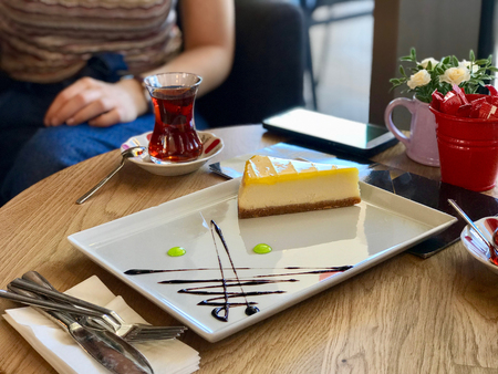 Lemon Cheesecake Served at the Restaurant with Turkish Tea. Dessert Concept.