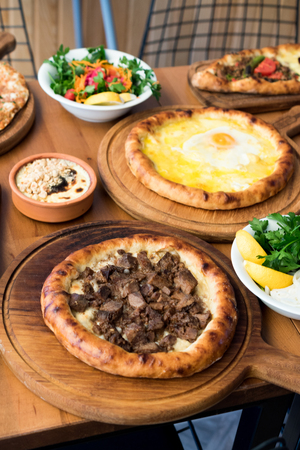 Variety of Turkish Pide Traditional food with beef, Cheese, Fried Egg and Salad. Traditional Foo.の写真素材