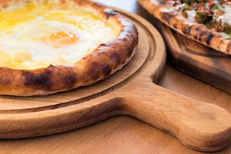 Turkish Round Pide with Fried Egg and Cheese. Traditional Food.の写真素材