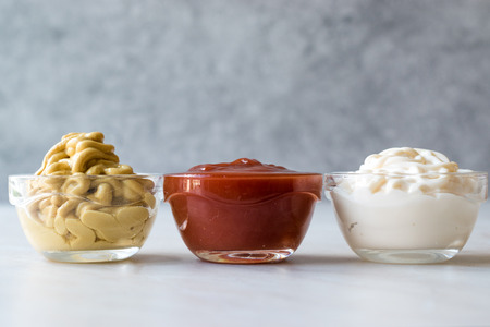 Set of Three Classic Sauce Ketchup, Mayonnaise and Mustard in Small Glass Bowls. Fast Food Sauce.の写真素材