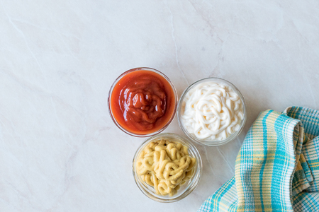 Set of Three Classic Sauce Ketchup, Mayonnaise and Mustard in Small Glass Bowls. Fast Food Sauce.の写真素材