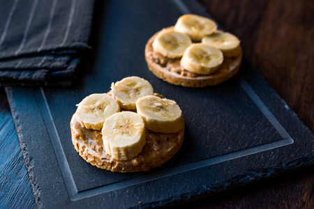 Bulgur Rice Cakes with Sliced Bananas and Peanut Butter / Round Crackers. Organic Healthy Snacks.の写真素材
