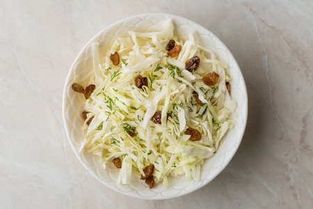 White Cabbage Salad Sauerkraut with Dry Raisins and Dill. Traditional Organic Food.の写真素材