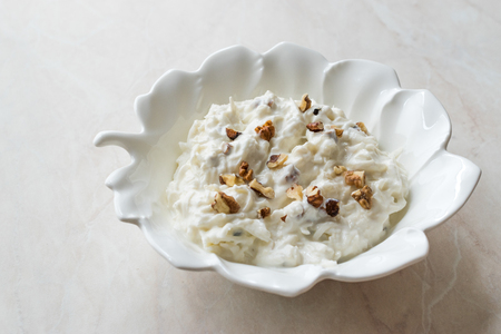 Celery Salad with Yogurt and Walnuts in Leaf Shaped Plate.の写真素材
