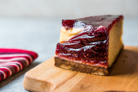 Raspberry Cheesecake Slice on Wooden Board with Paper. Organic Dessert.の写真素材