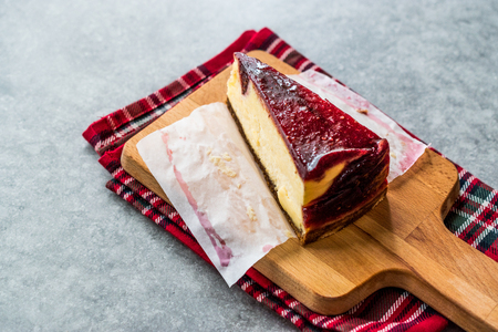 Raspberry Cheesecake Slice on Wooden Board with Paper. Organic Dessert.の写真素材