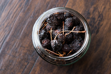 Jar of Dried Cherry Ready to Eat on Dark Wooden Surface. Organic Food.の写真素材