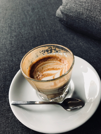 Glass of Picolo Latte Coffee on Sofa / Cortado. Organic Beverage.