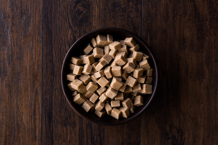 Raw Organic Brown Sugar Cubes in Wooden Bowl Ready to Eat. Food Product.の写真素材