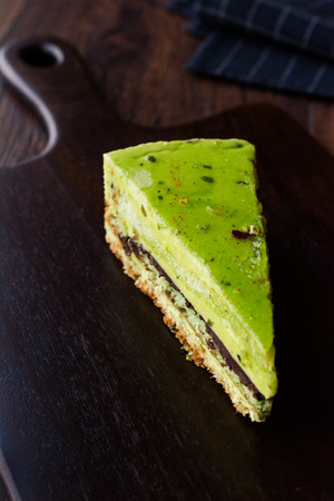 Matcha Green Tea Layer Cake Slice on Dark Wooden Board. Organic Dessert.の写真素材