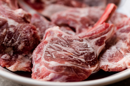 Raw Frozen Bloody Lamb Chops Meat in Plate Organic Protein Food.の写真素材
