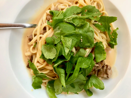 Linguini Pasta with Lamb Meat, Cream Sauce and Arugula, Rocket or Rucola Leaves. Traditional Organic Food.の写真素材