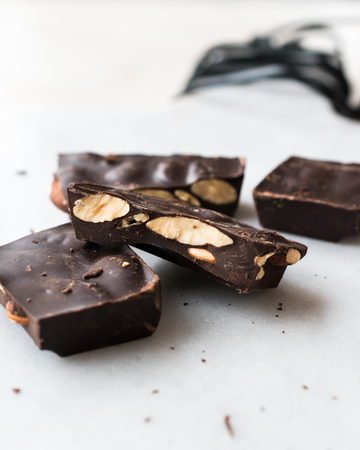 Bitter Almond Chocolate Pieces on White Marble Surface. Organic Snacks.の写真素材