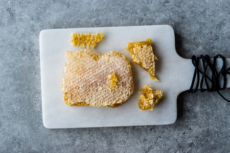 Fresh Honeycomb Slices with Honey on Marble Board. Organic Food.