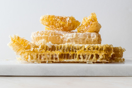 Fresh Honeycomb Slices with Honey on Marble Board. Organic Food.の写真素材