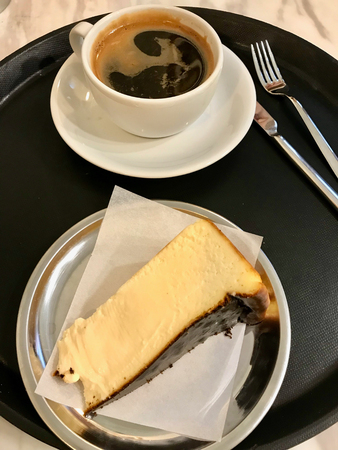 San Sebastian Cheesecake Slice with Americano Coffee served with Tray at Cafe Shop. Dessert at Restaurant.の写真素材