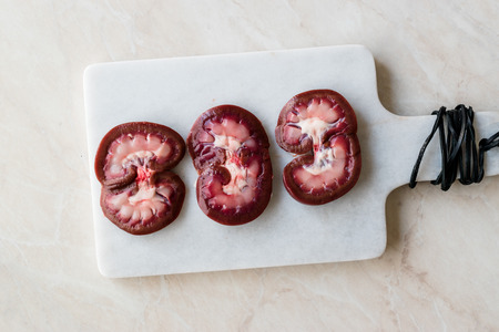 Sliced Raw Lamb Kidney on Marble Board. Organic Product.の写真素材
