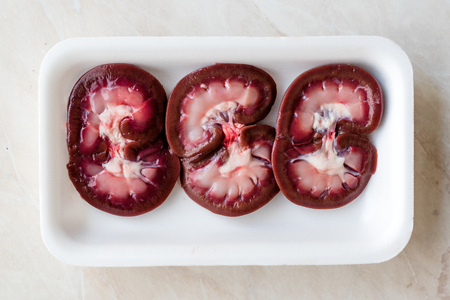 Raw Lamb Kidney Slices in Plastic Container Box / Package. Organic Product.