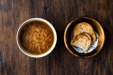 French Onion Soup with Bread on Dark Wooden Surface. Traditional Organic Food.の写真素材