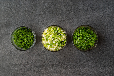 Chopped Chives, Parsley and Dill in Glass Bowls. Organic Food.の写真素材