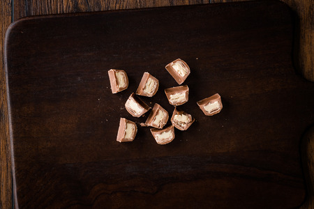 Tahini Filled Chocolate Pieces on Dark Wooden Surface / Tahin. Organic Snacks.